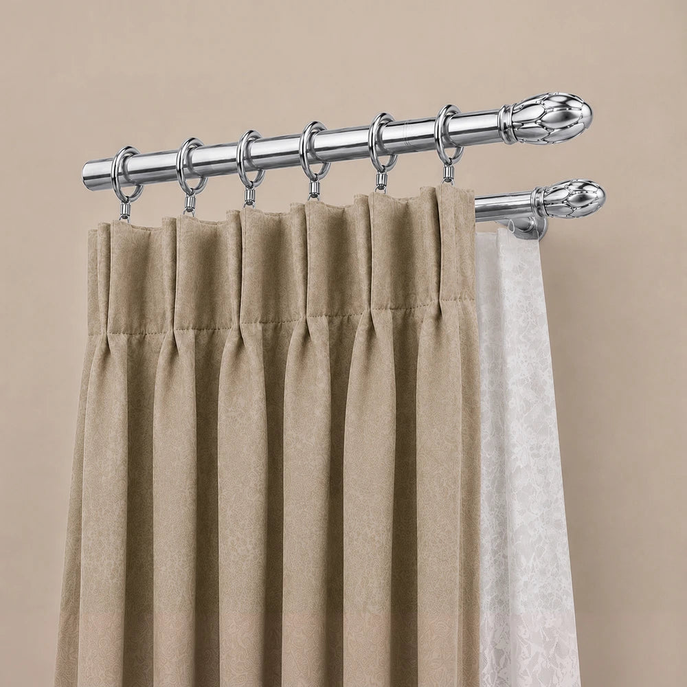 16mm curtain rod rings with a chrome finish, supporting beige drapes and a white sheer curtain