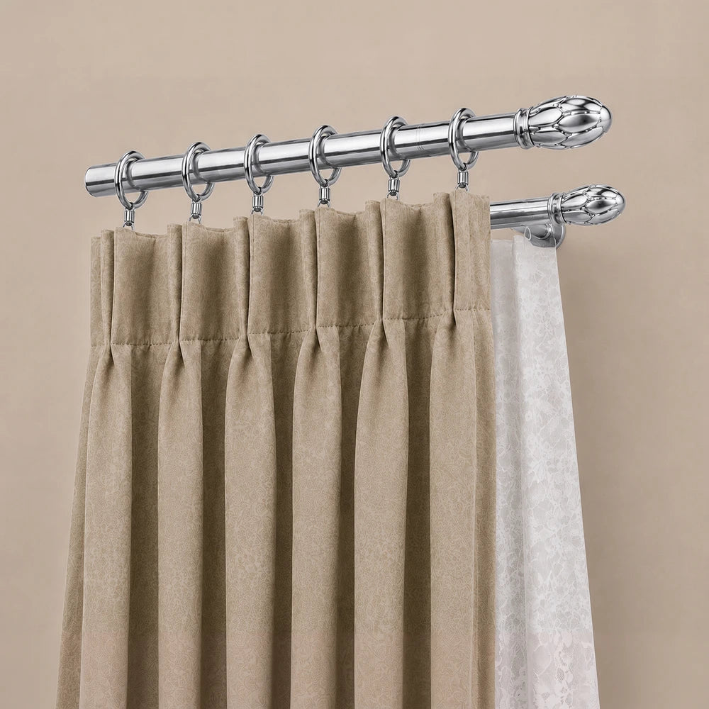 25mm Curtain Rod Rings in silver metal with beige curtains hung on a decorative rod for window treatment