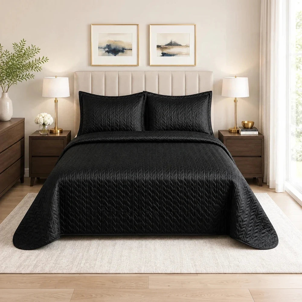 3Pc Ultrasonic Satin Quilt set in black with matching quilted shams on a neatly made bed, featuring elegant chevron