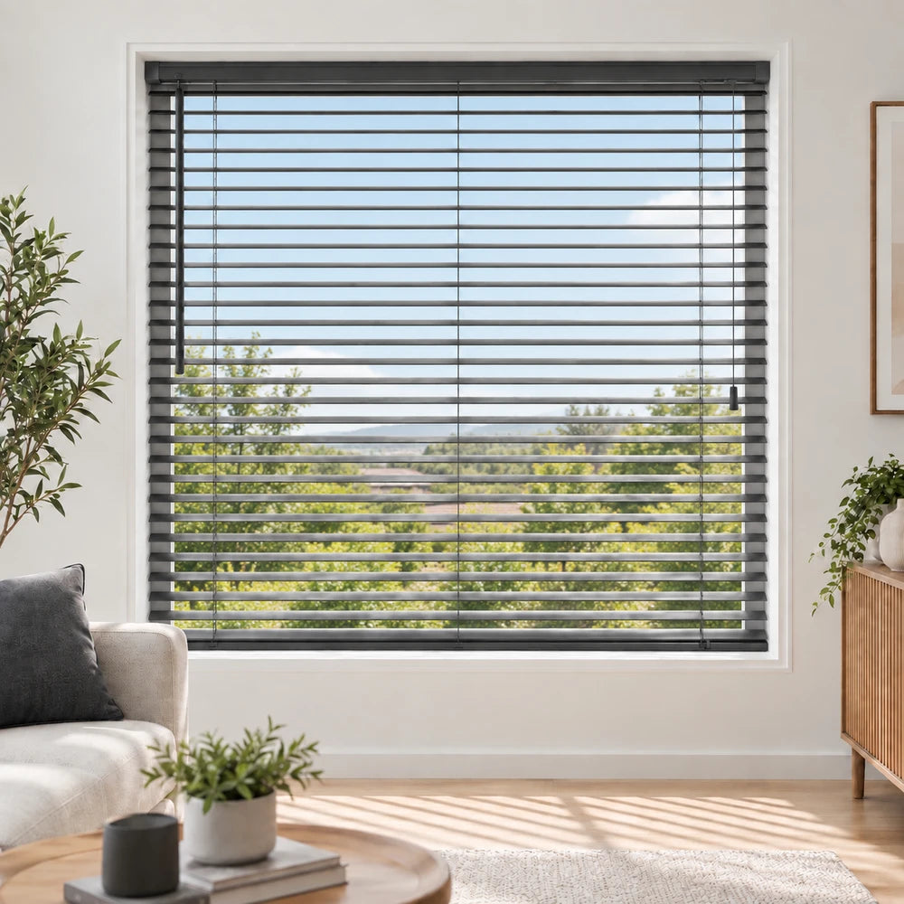 Aluminium blinds in charcoal gray on a large window, with adjustable slats for light control in a bright living room.