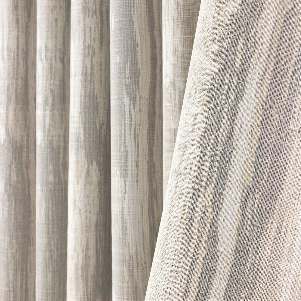 Barkweave Eyelet Lined Curtain in beige and gray with a woven textured fabric and soft, flowing drape.