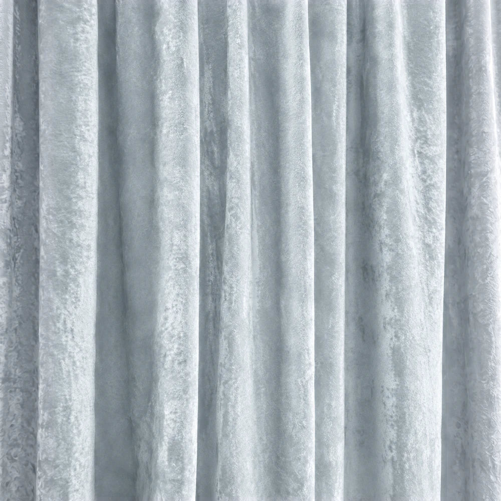 Carducci Abstract Velvet Unlined Eyelet Curtain in light blue velvet with soft drape and textured folds.