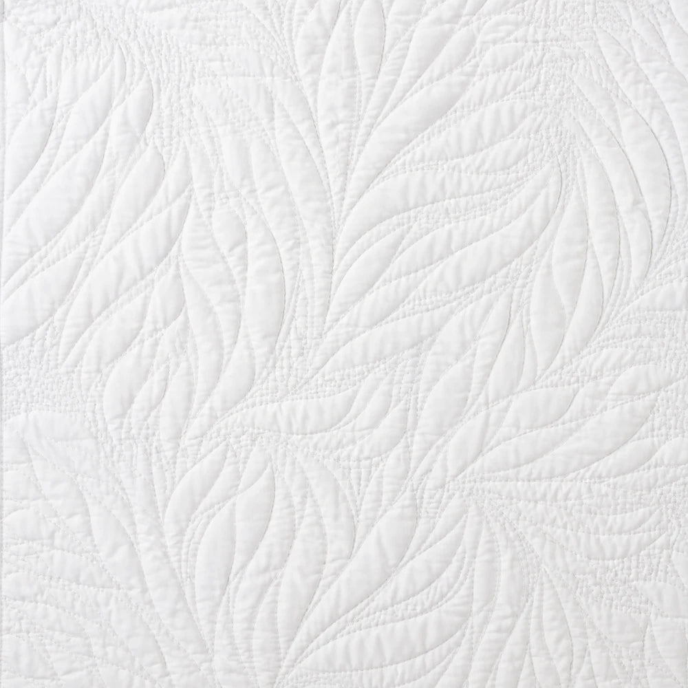 Carducci Katarina 100% cotton quilt in white with an intricate leaf-inspired quilted pattern, close-up view highlighting the
