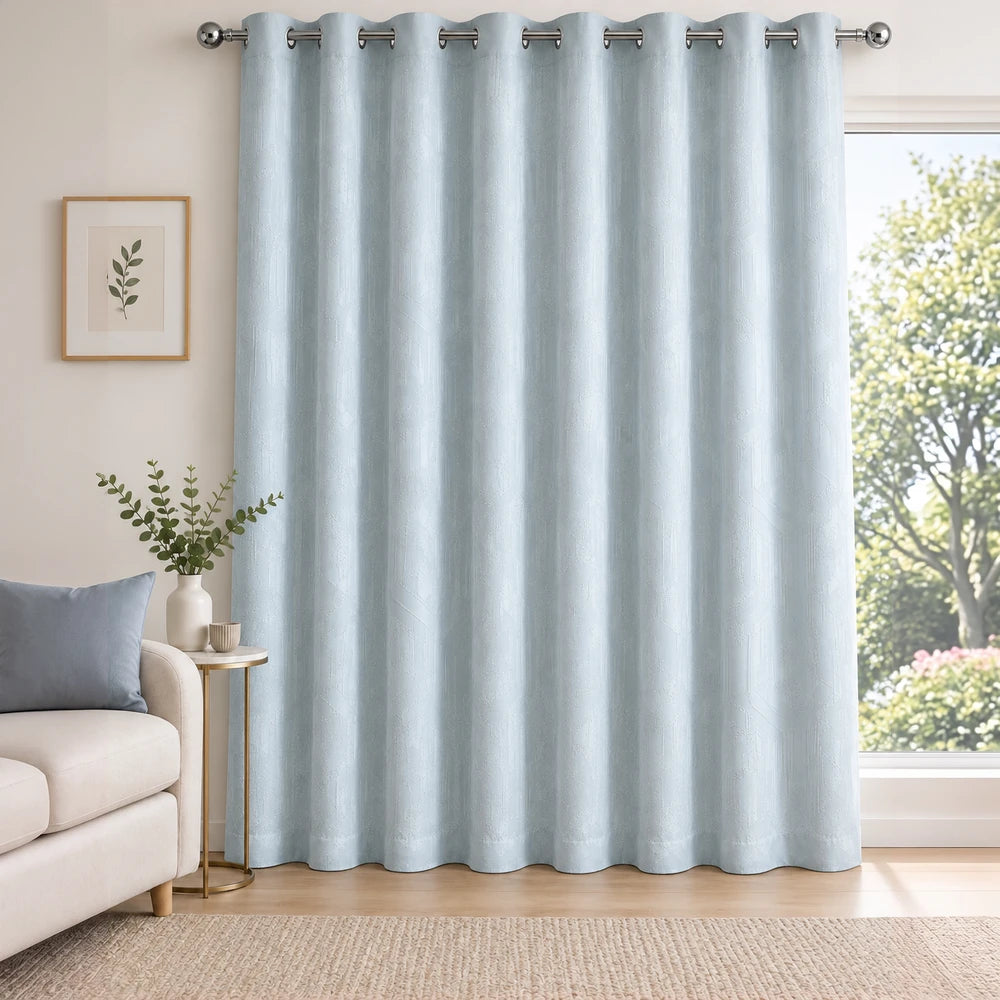Carducci velvet textured unlined eyelet curtain in soft blue, showcasing a smooth drape and metallic grommet header for easy