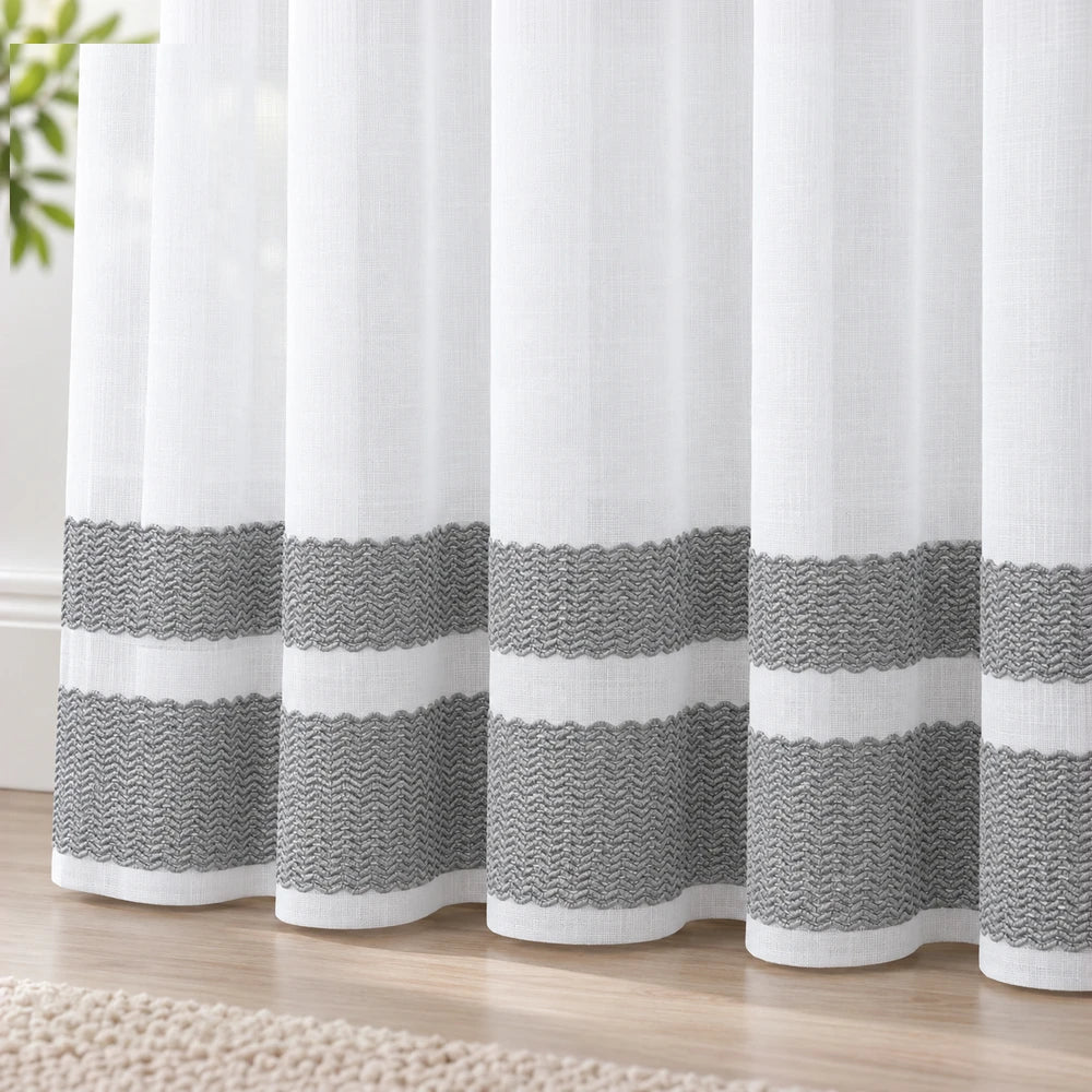 Cecile Balza Alter taped curtain in white fabric with gray chevron-textured bands along the lower portion.