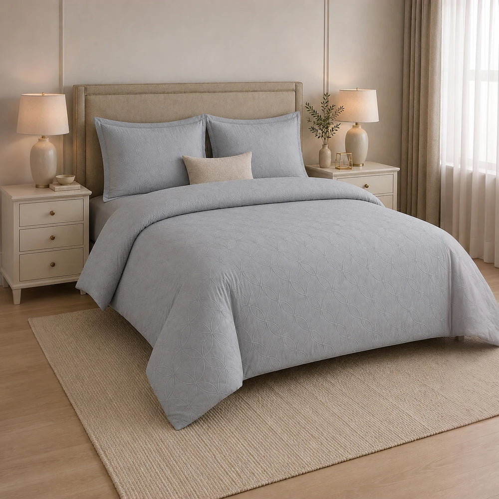 Cotton Co Ashley Duvet Cover Set in grey with a subtle quilted geometric pattern, shown on a neatly made bed.