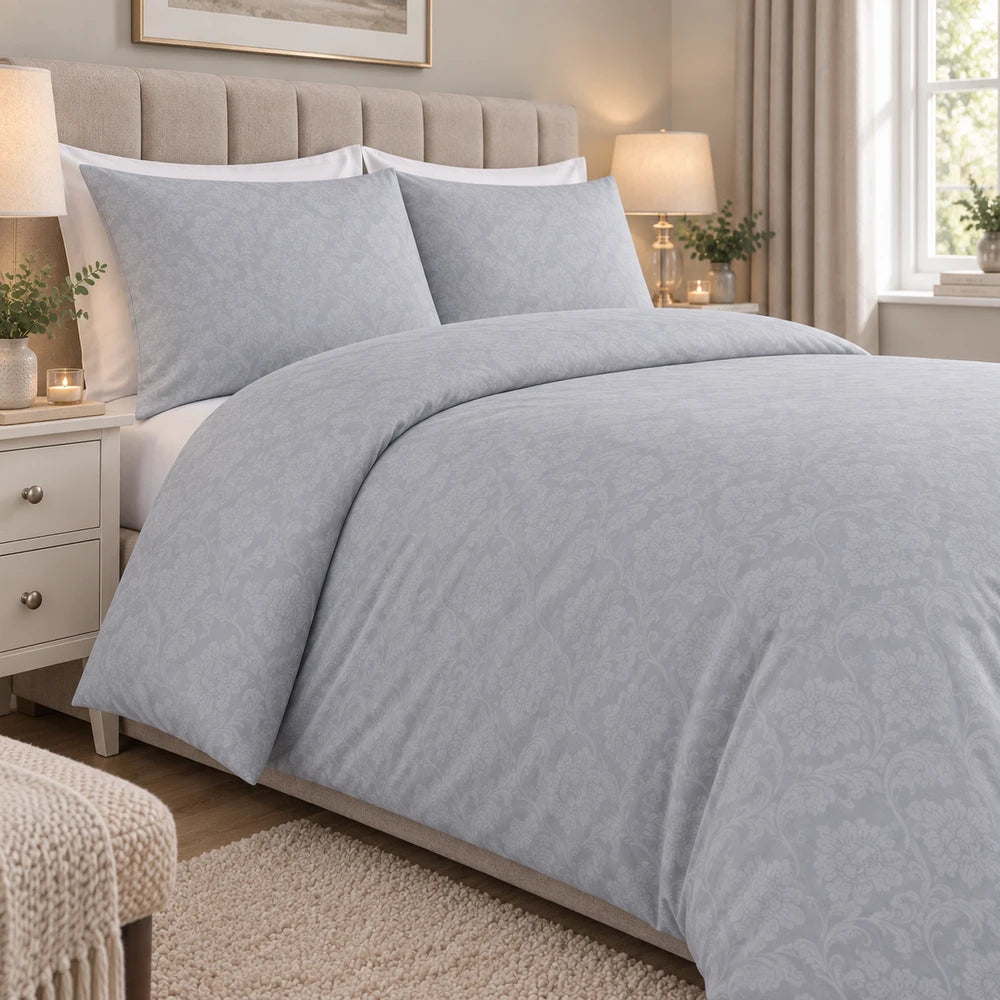 Cotton Co Kate Duvet Cover Set in grey with a subtle damask pattern, shown on a neatly made bed.