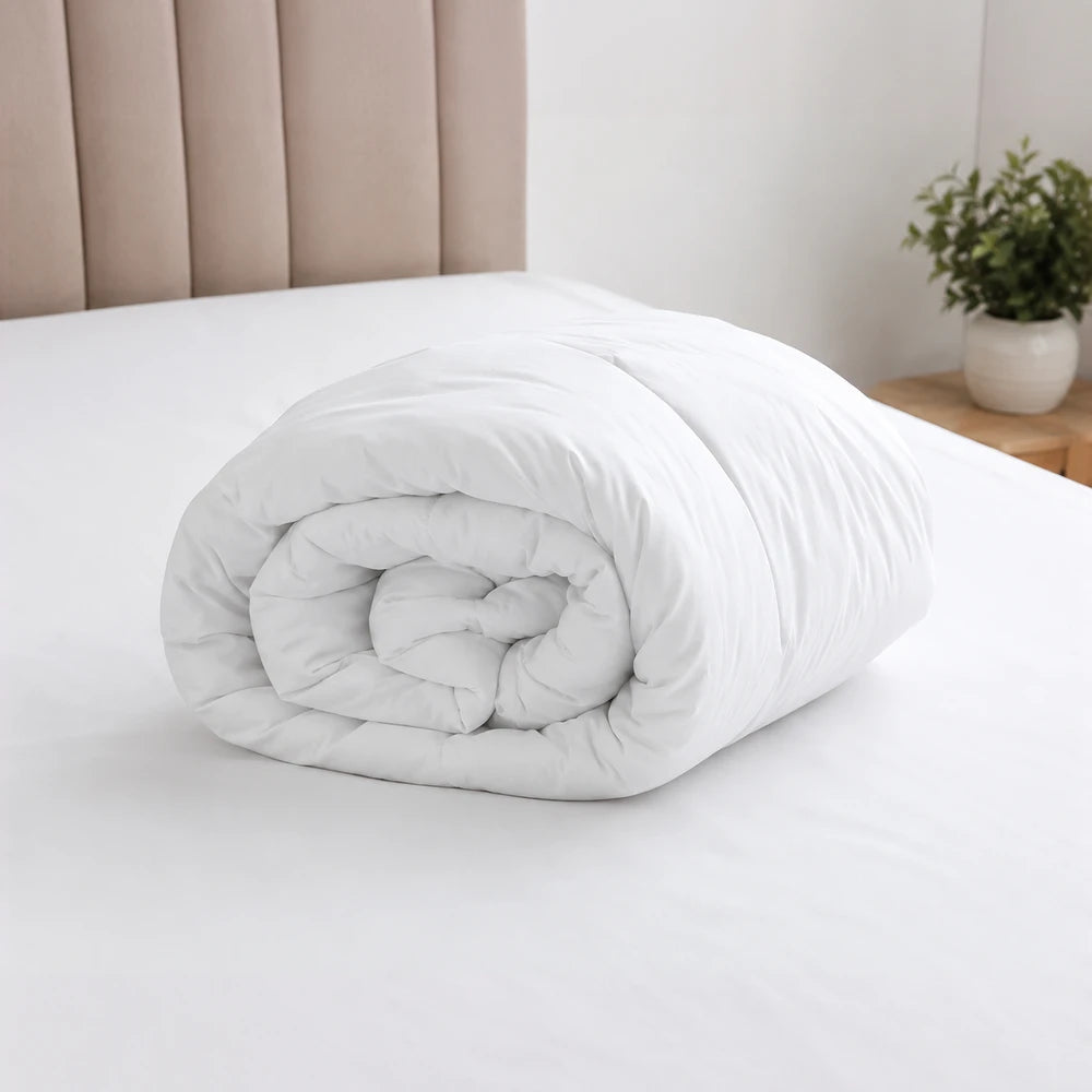 Eco-fibrefill Duvet Inner in white, rolled for display, showing soft, plush filling and smooth fabric.