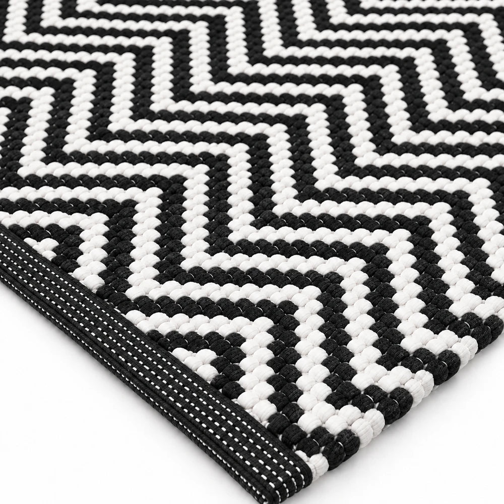 Ethnic Bathroom Mat Set in black and white geometric weave, woven textile, non-slip edge for bathroom floor use.