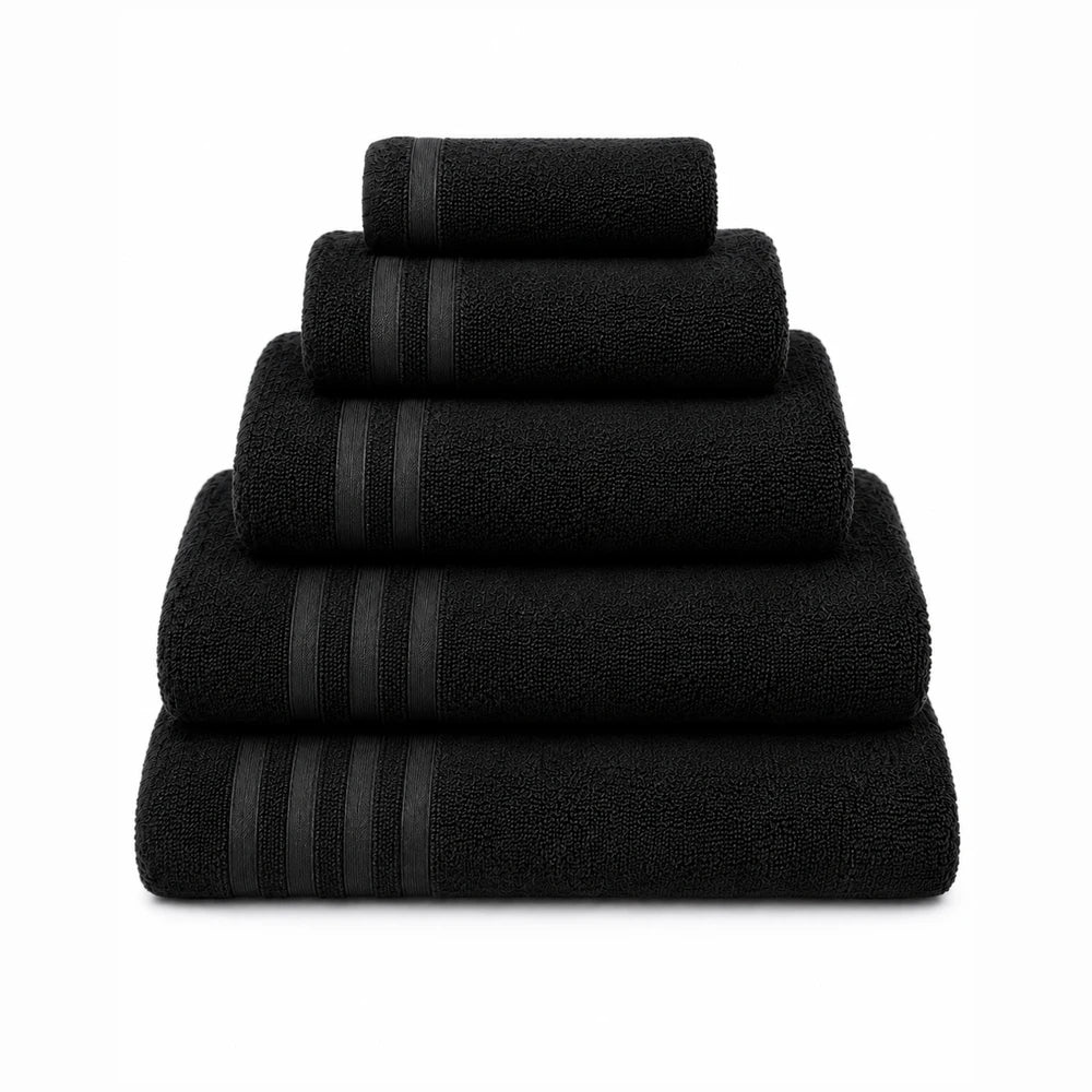 Everyday Towels black set featuring bath, hand, and face towels with a plush looped texture and subtle border stripes.