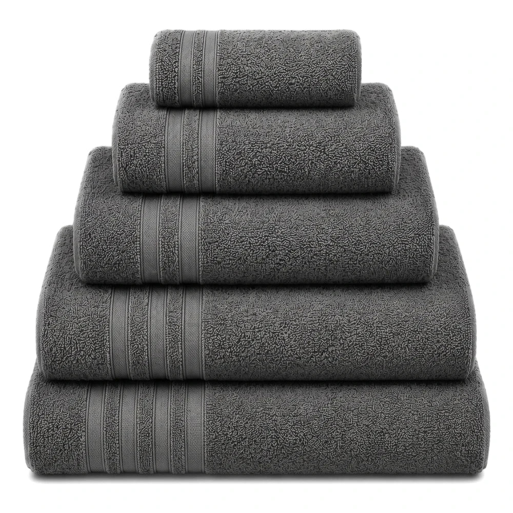 A stack of dark grey Everyday Towels, made from soft terry fabric, neatly folded and arranged in a pyramid.