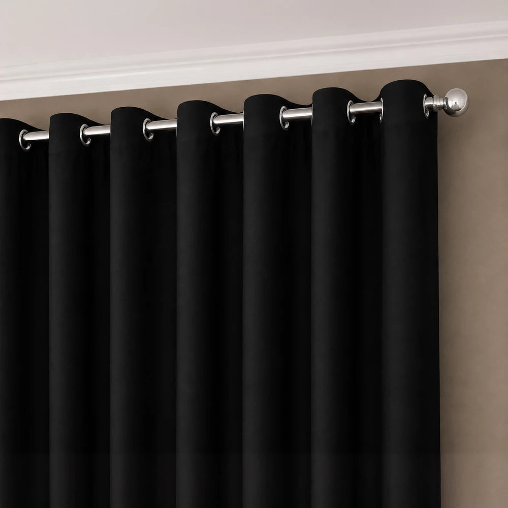 Faux silk eyelet-lined curtain in black showcasing silver metal grommets for easy hanging and a smooth, draped look.