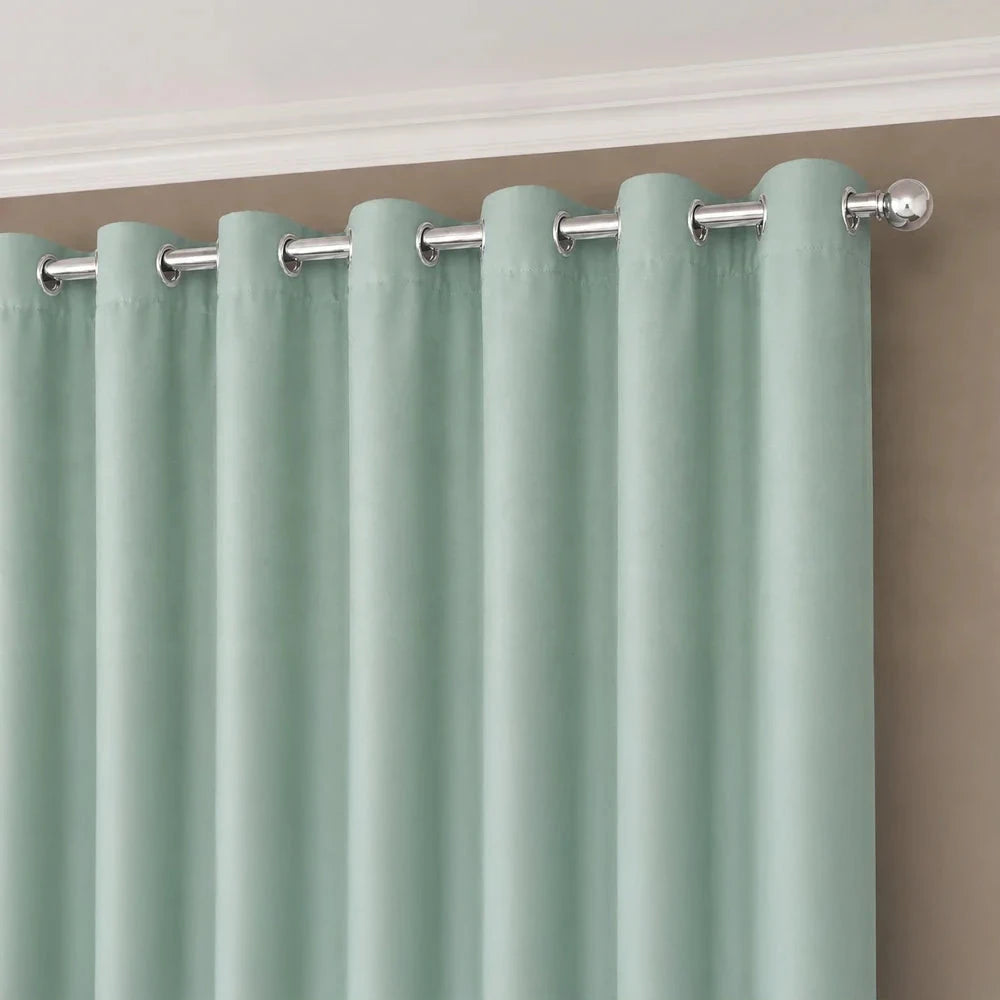 Faux silk eyelet-lined curtain in mint green with metal grommets for easy hanging and a smooth drape.