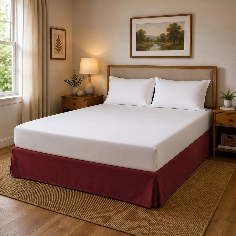 Microfibre Base Wrap on a neatly made bed with white sheets and burgundy bed skirt in a cozy bedroom.