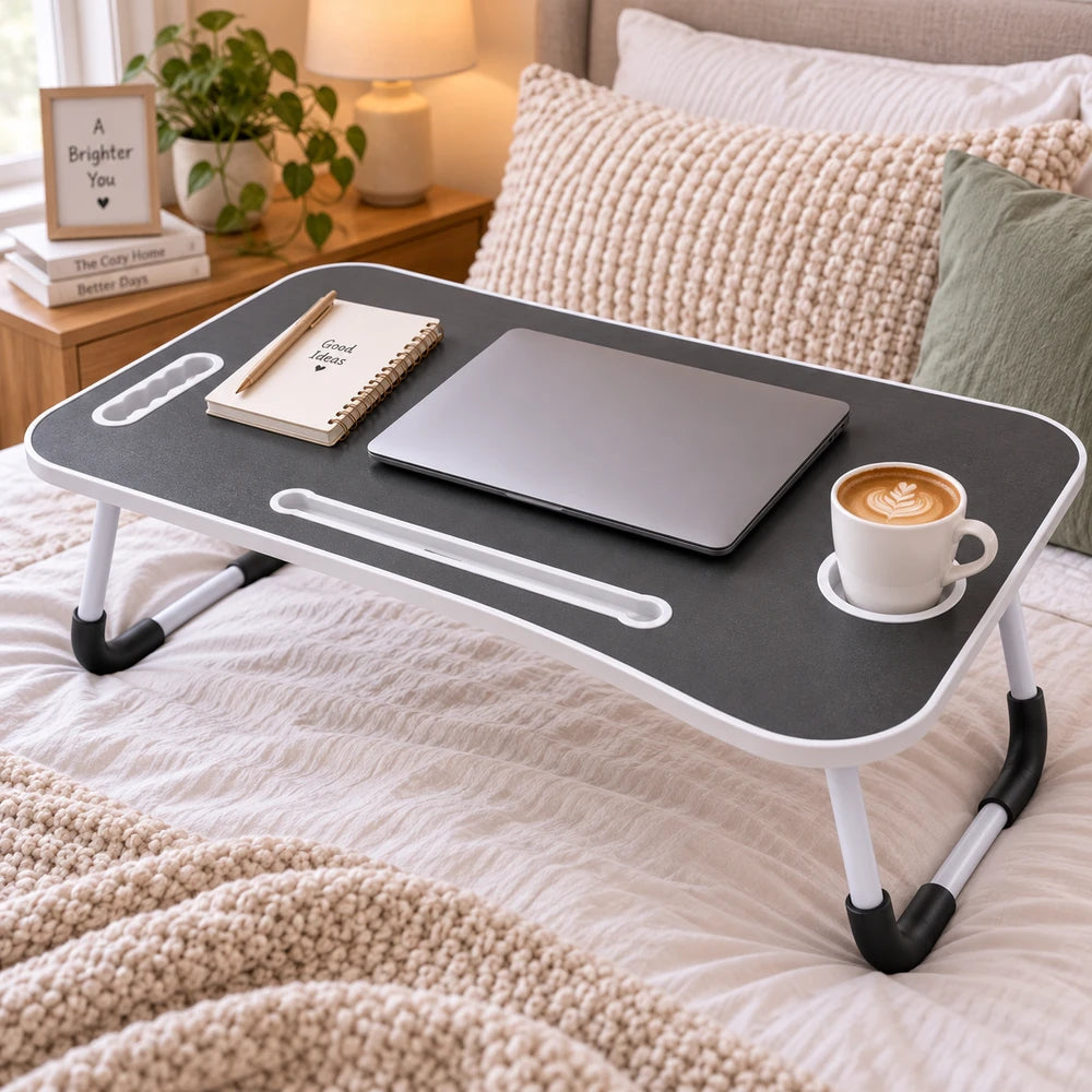 Multi-Functional Foldable Laptop Table & Serving Tray with black top and white frame, over-bed desk supporting a laptop and