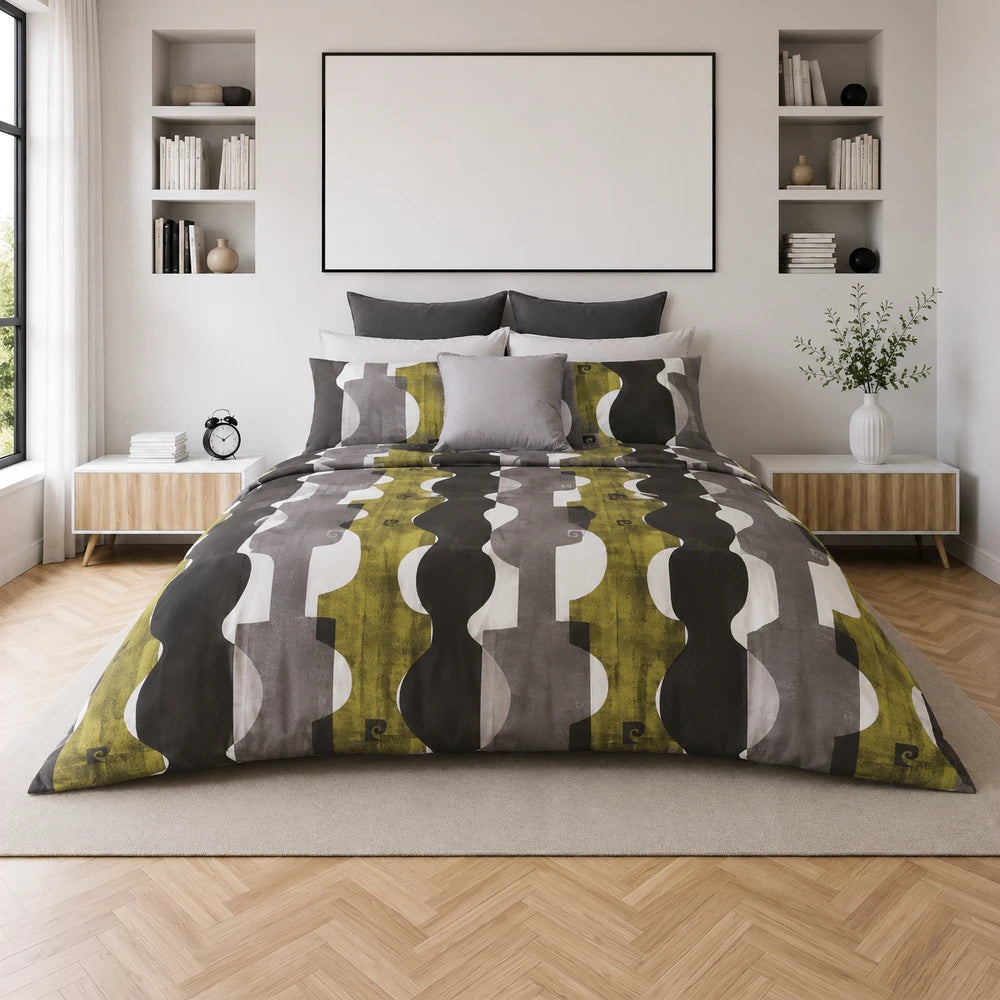 Pierre Cardin Microfibre Cover Set Branson on a modern bed featuring a green, grey and white geometric pattern.