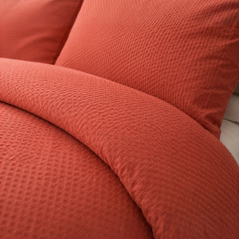 Pierre Cardin Bubble Embossed Microfibre Duvet Cover in orange with a raised dot texture, comfortable and stylish.