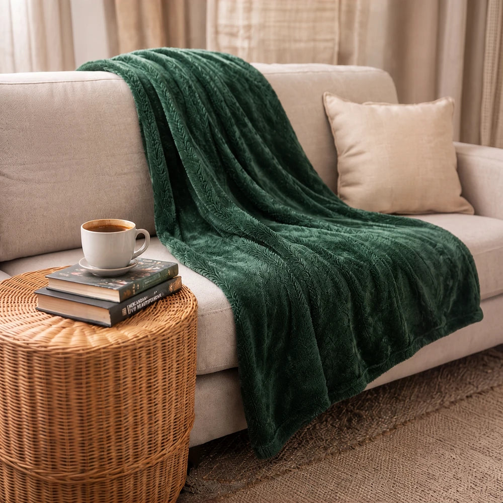 Pierre Cardin Classic Woven Throw in deep emerald green with plush textured weave, perfect for cozying up on the sofa.