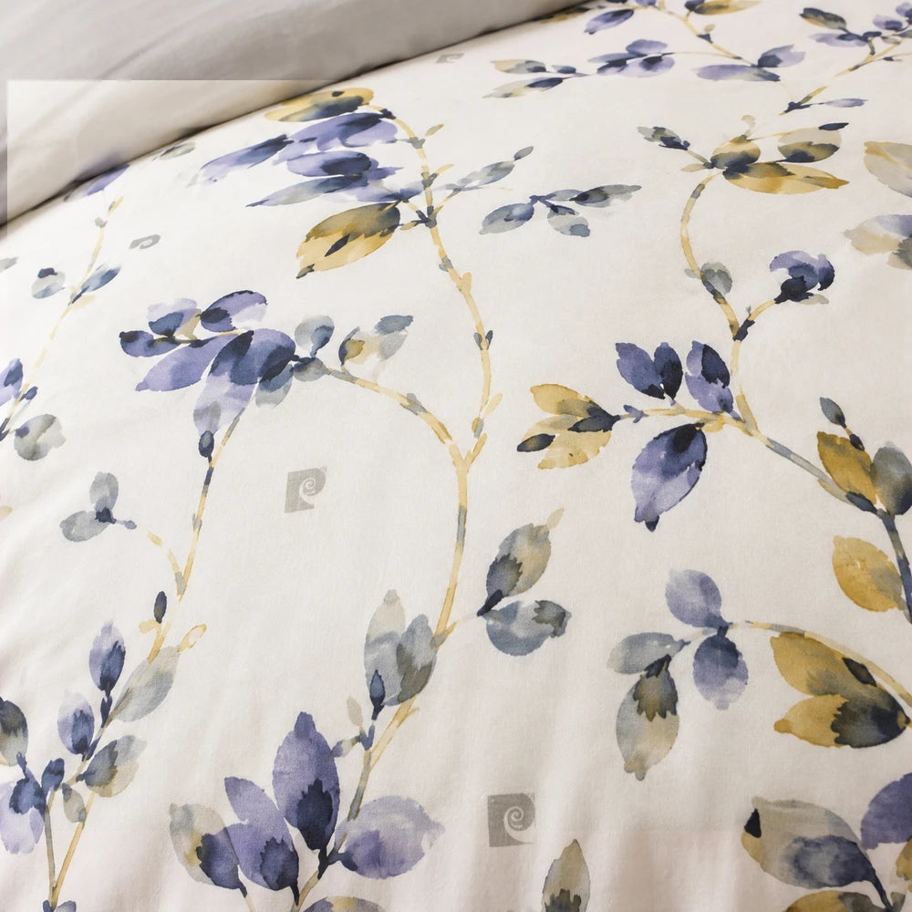 3 Piece Pierre Cardin Comforter with watercolor floral design in purple, blue, and ochre on a light background