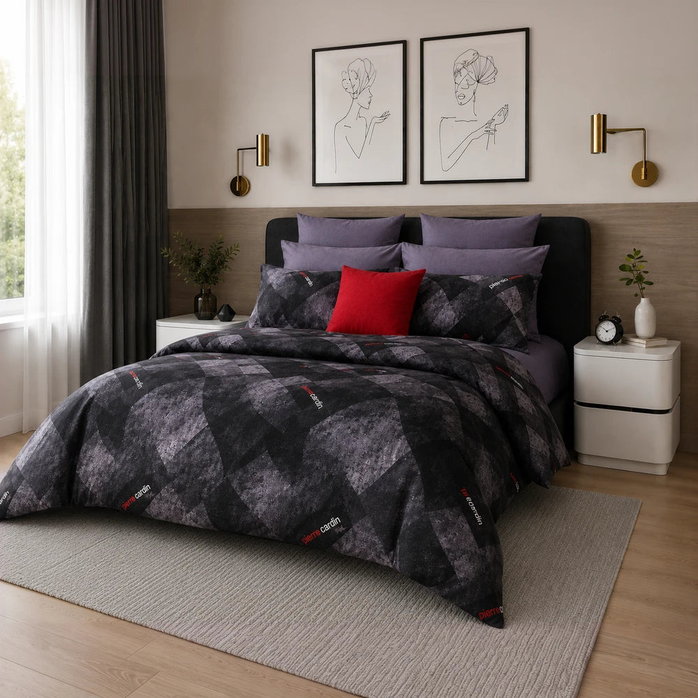 Pierre Cardin 3 Piece Comforter set in dark gray and black diamond pattern with purple pillow shams on a modern bed.