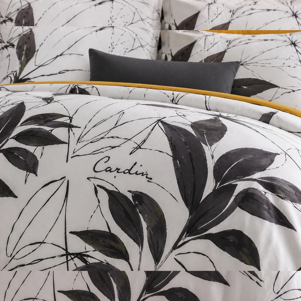Pierre Cardin Microfibre Duvet Cover Set in Botanist Leaf with white base, black botanical print and yellow piping visible