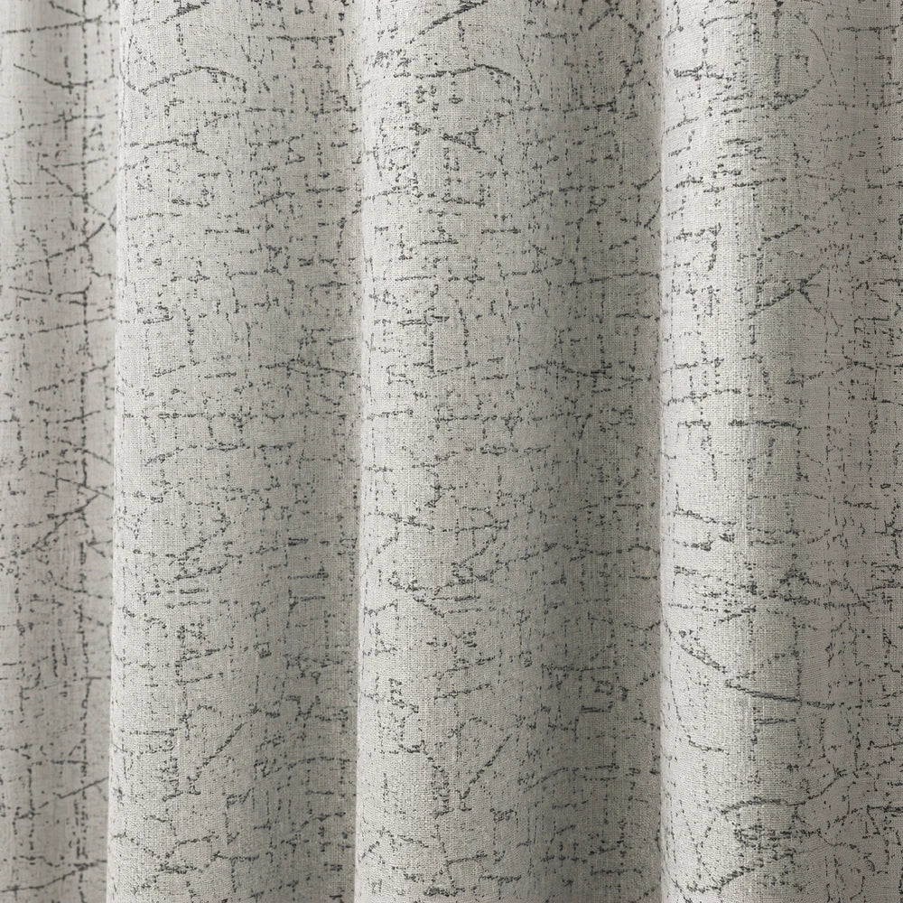 Pierre Cardin Eyelet Lined Jacquard Curtain in light beige with a textured gray pattern, designed for elegant hanging and