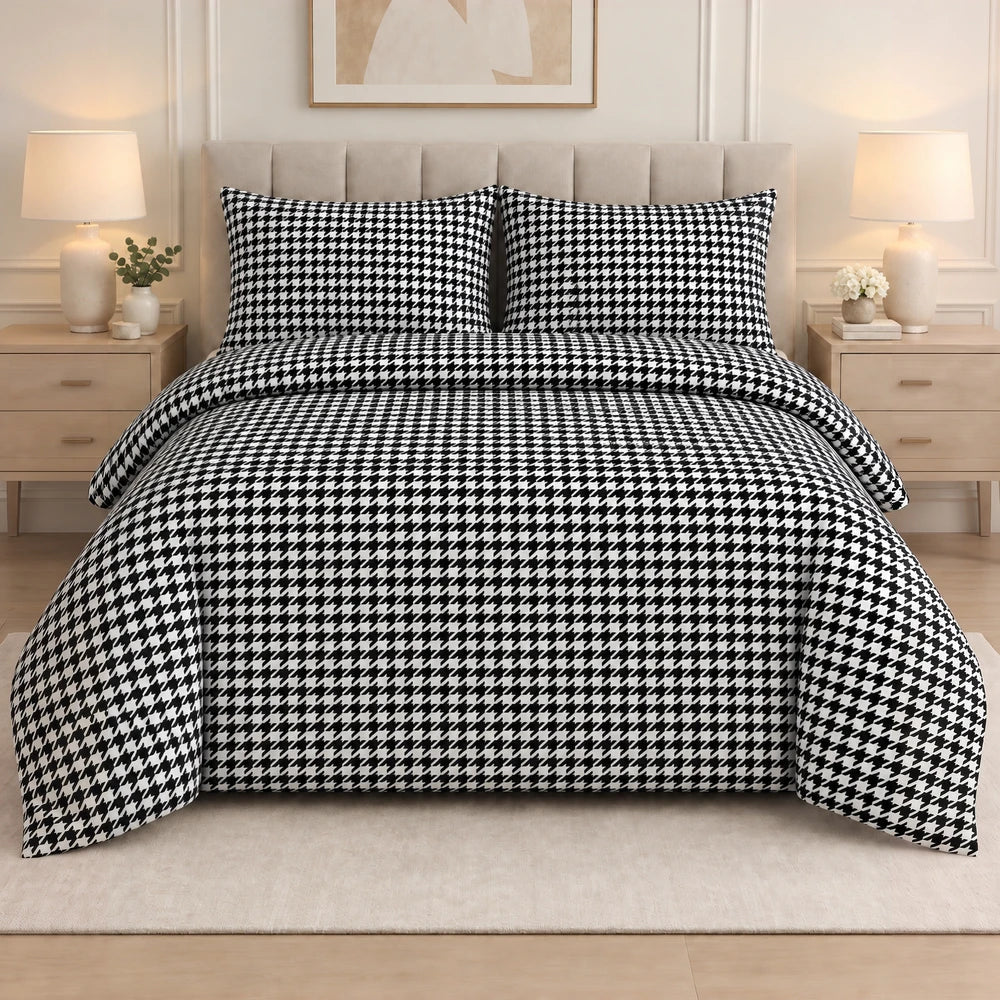 3Pc Pierre Cardin printed houndstooth quilt set with matching shams in black and white on a bed