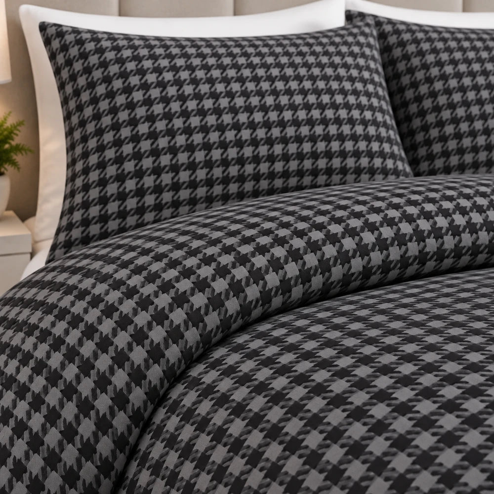 3Pc Pierre Cardin printed houndstooth quilt with matching shams in grey and black, featuring a bold geometric pattern.