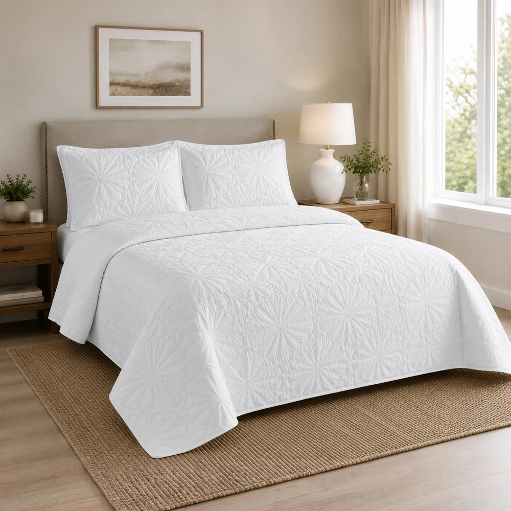 3pc pierre cardin pinsonic quilt bedding set in white with decorative quilting on a neatly made bed.