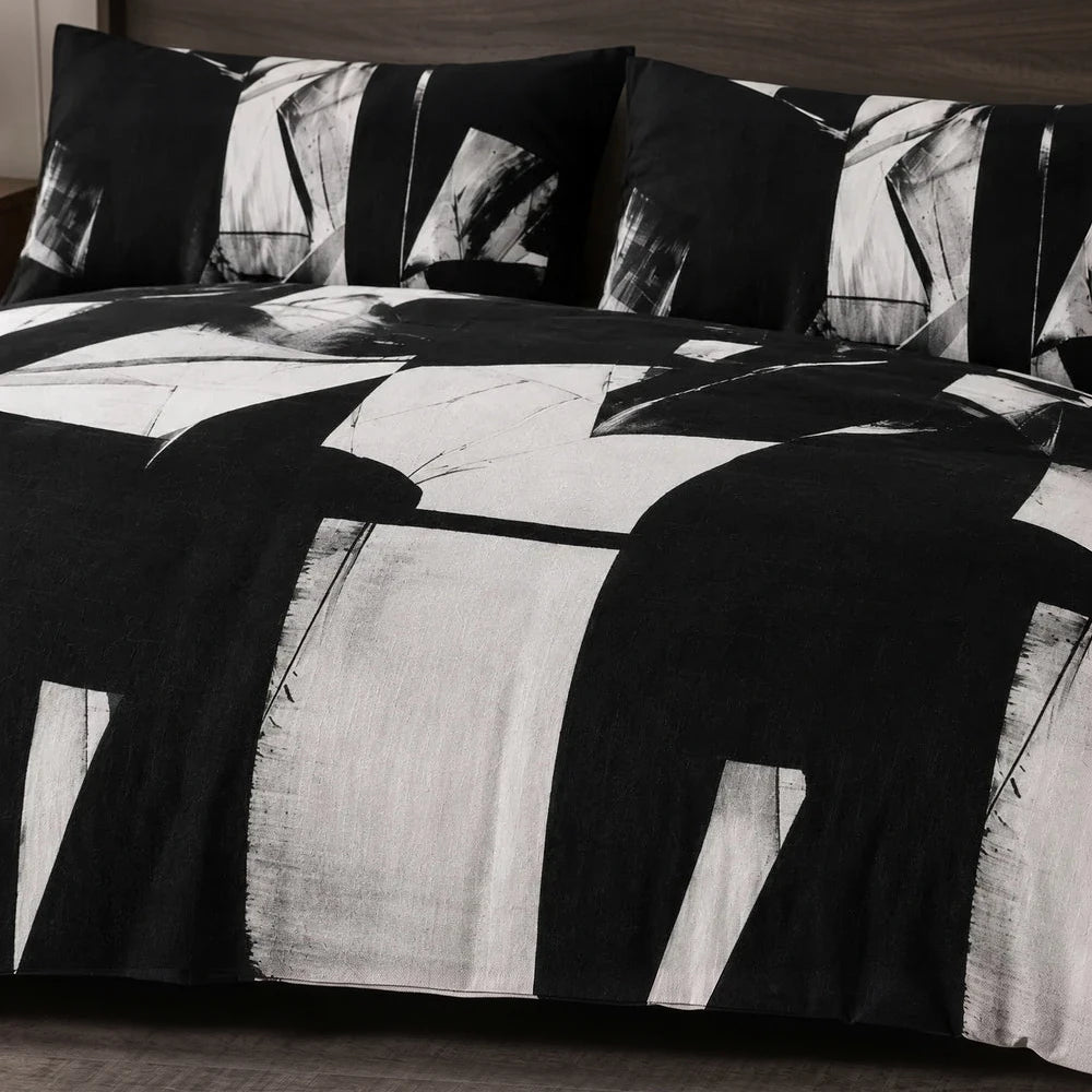 Pierre Cardin Vogue Duvet Cover Set in black and white abstract geometric pattern, includes duvet cover and pillow shams.