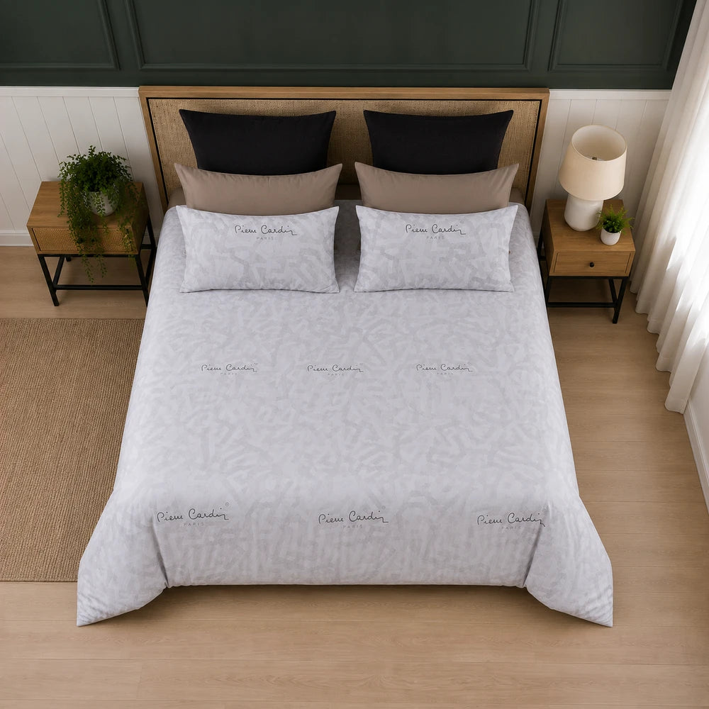 Pierre Cardin Vogue Duvet Cover Set in light gray with subtle geometric pattern and matching pillowcases on a neatly made