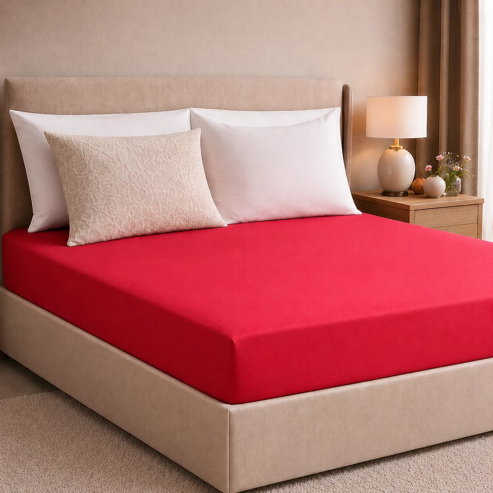 Plain microfibre fitted sheet in red, smooth soft texture, designed to fit a standard mattress