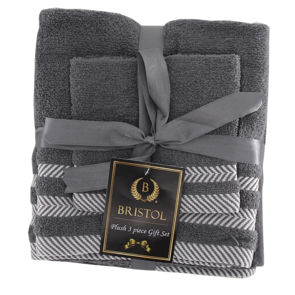 A plush 3-piece grey towel gift set, neatly folded and tied with a matching grey ribbon, featuring a striped pattern on the