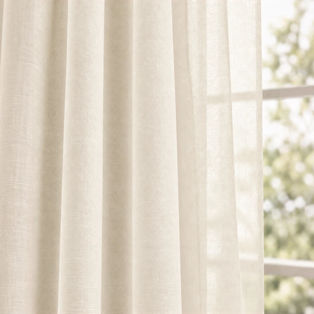 Premium taped muslin ready-to-hang curtain in cream with lightweight, breathable fabric and soft translucent drape.