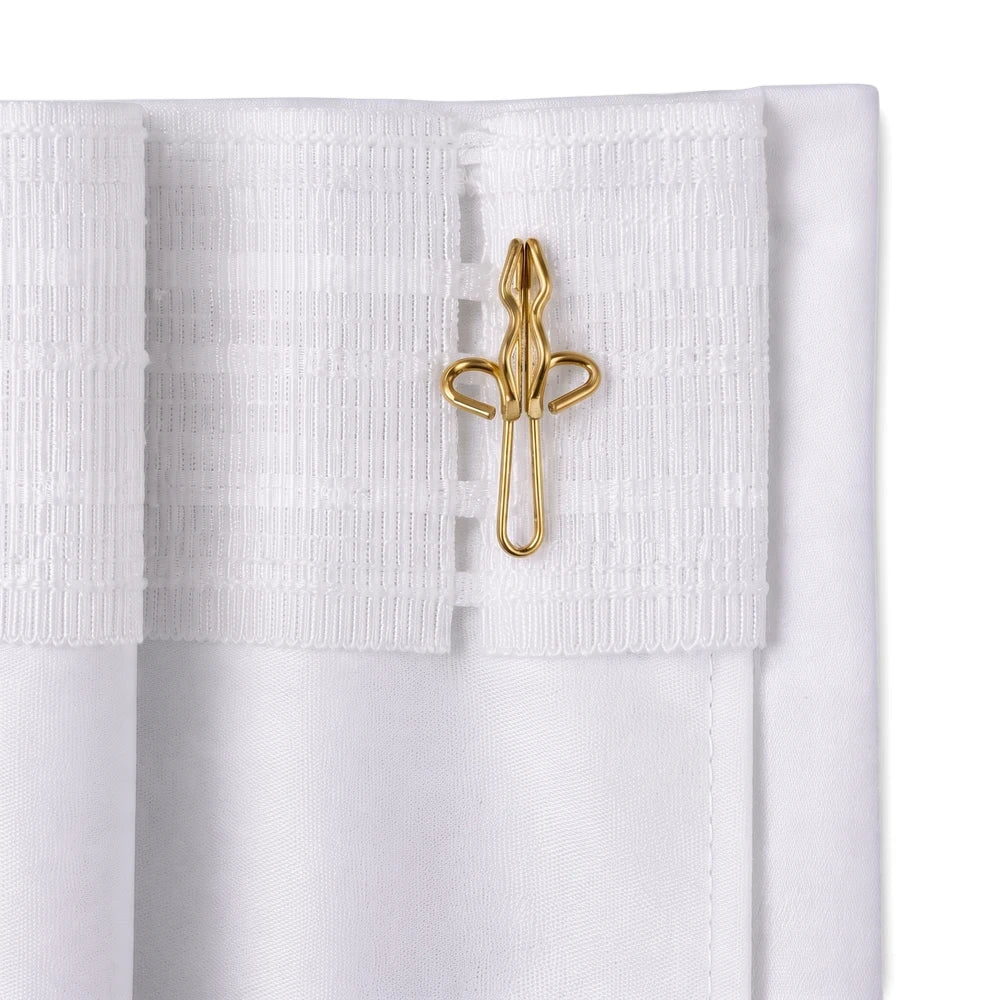 Close-up of golden R7 curtain hooks attached to the pleated top of a white curtain fabric.