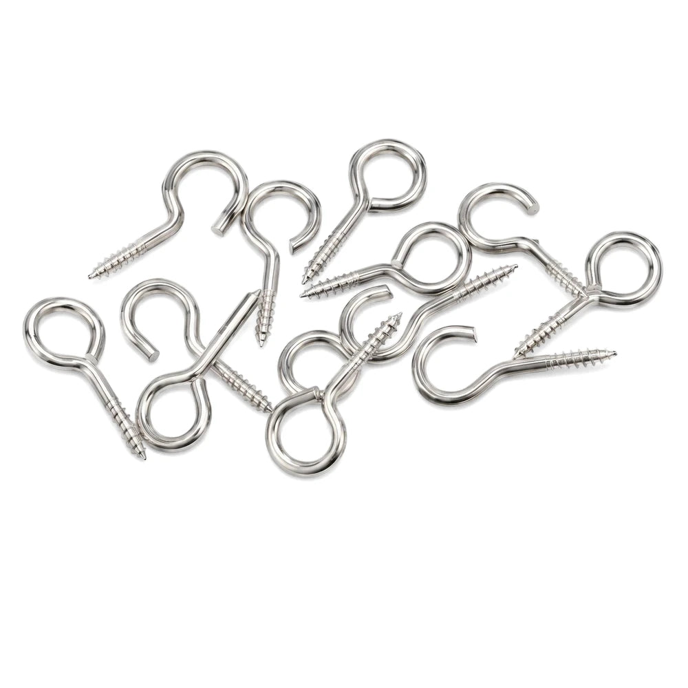 A scattered group of shiny metal curtain wire hooks and eye screws on a white background, viewed from above.