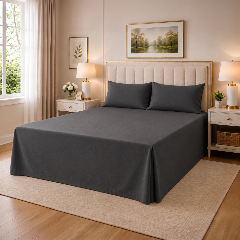 Tela Milano Easy Fit Combo bedspread in dark gray with matching pillow shams on a neatly made queen bed in a stylish bedroom.