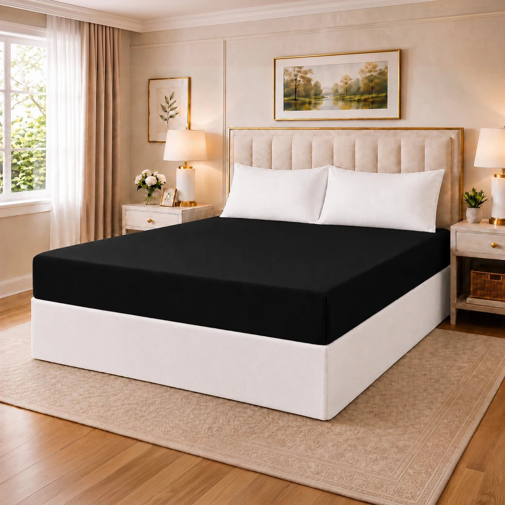 Tela Milano Microfibre Fitted Sheet in black on a neatly made bed with white pillows