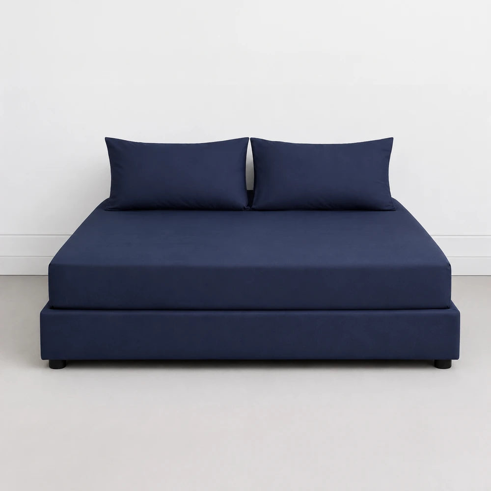 Whisper Soft Microfibre Easybed Combo Set on a navy blue bed with matching navy pillows.