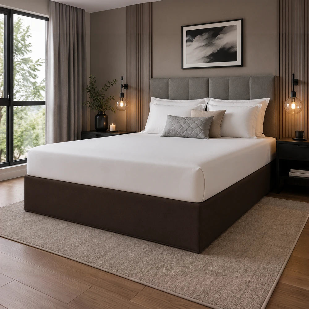 Whisper Soft Microfibre Bedwrap on a neatly made bed with white sheets and a gray upholstered headboard in a modern bedroom.