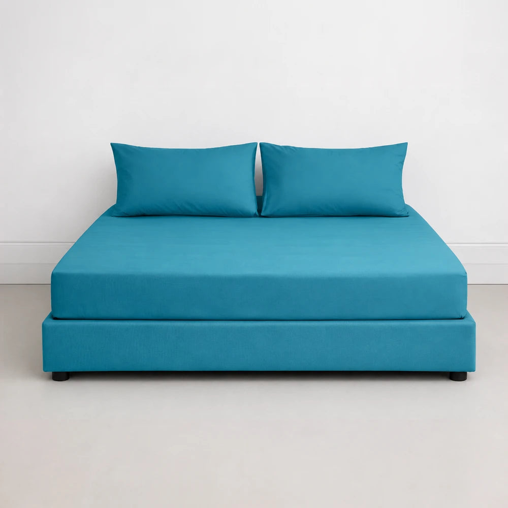 Whisper Soft Microfibre Easybed Combo Set on a turquoise blue bed with two pillows, featuring smooth fabric and a tidy,