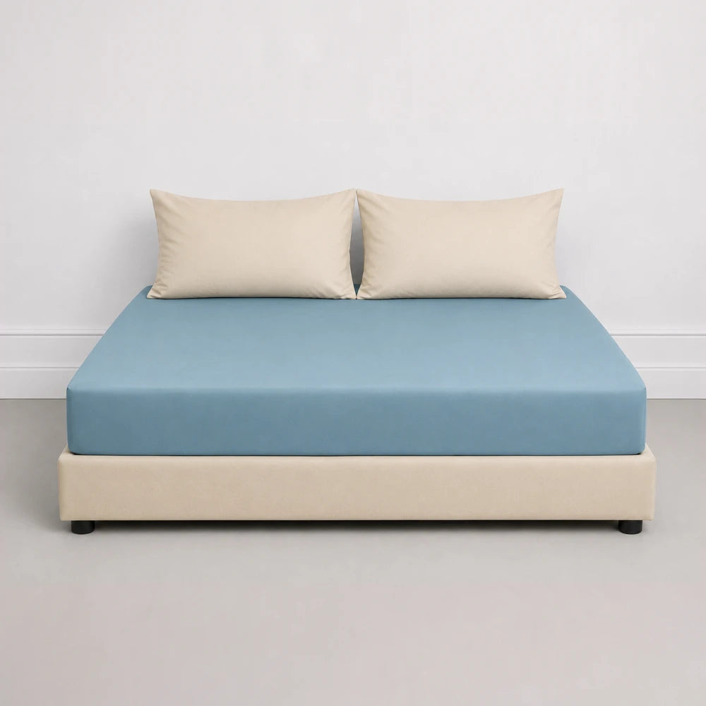 Whisper Soft Microfibre Fitted Sheet in blue on a bed with beige pillows, smooth microfiber fabric and snug fit.