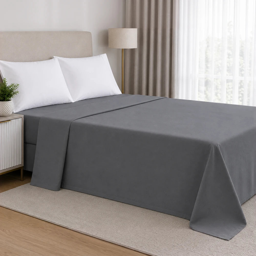 200TC 100% cotton percale flat sheet in dark gray on a neatly made bed with white pillows.