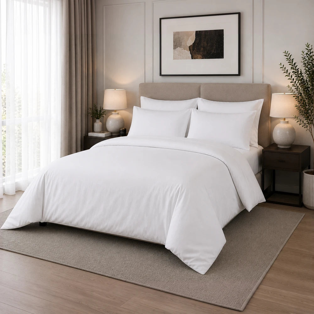 200TC 100% cotton percale plain duvet cover set in white on a neatly made bed with matching pillowcases