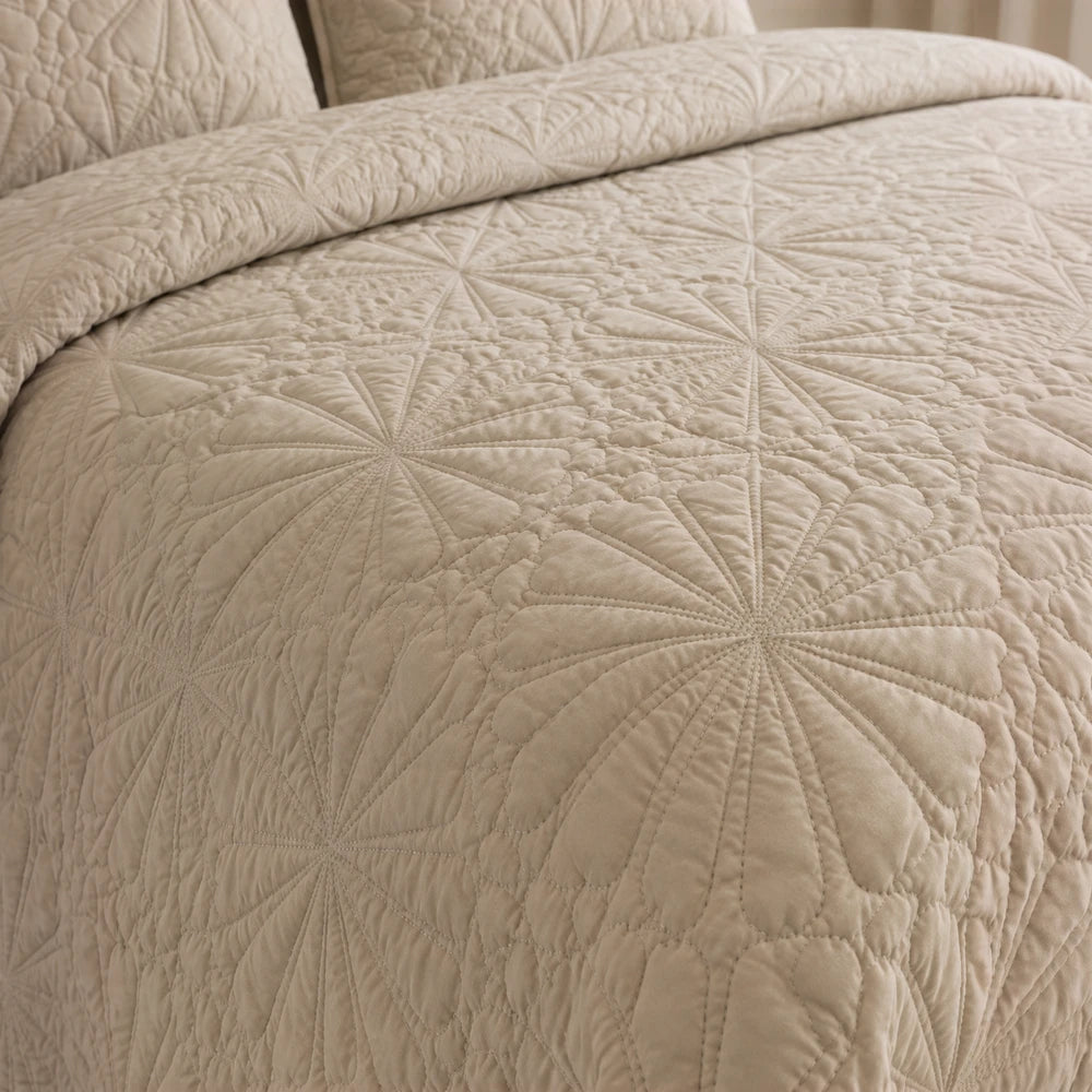 3Pc Pierre Cardin Pinsonic Quilt in beige fabric featuring a geometric starburst quilting pattern for a stylish, cozy bed.