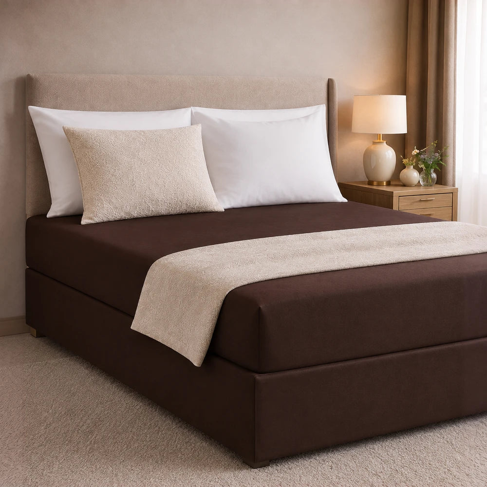 All-in-one fitted sheet and base cover in warm brown with a beige patterned accent pillow and runner for a coordinated