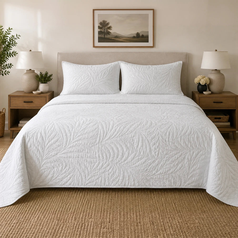 Carducci Katarina white quilt set in a neutral bedroom, 100% cotton with textured leaf quilting.