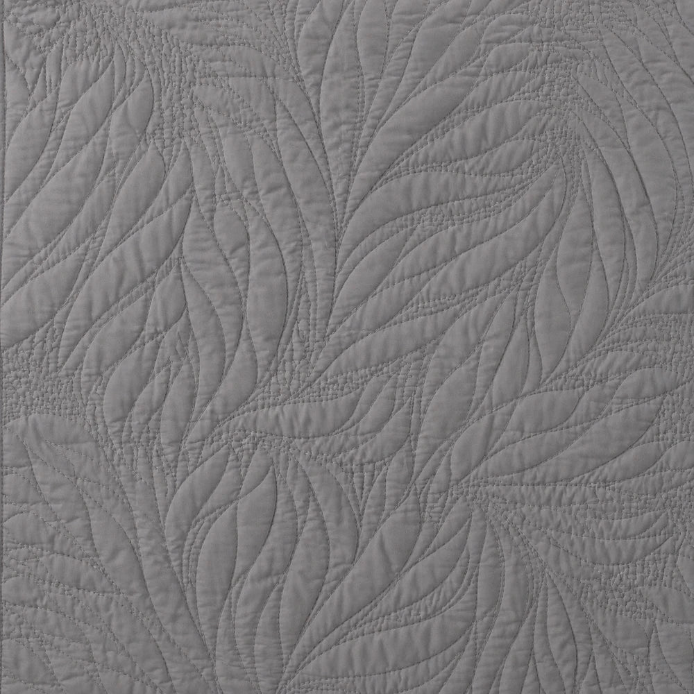 Carducci Katarina 100% cotton quilt in gray with an elaborate leaf and swirl quilting pattern.