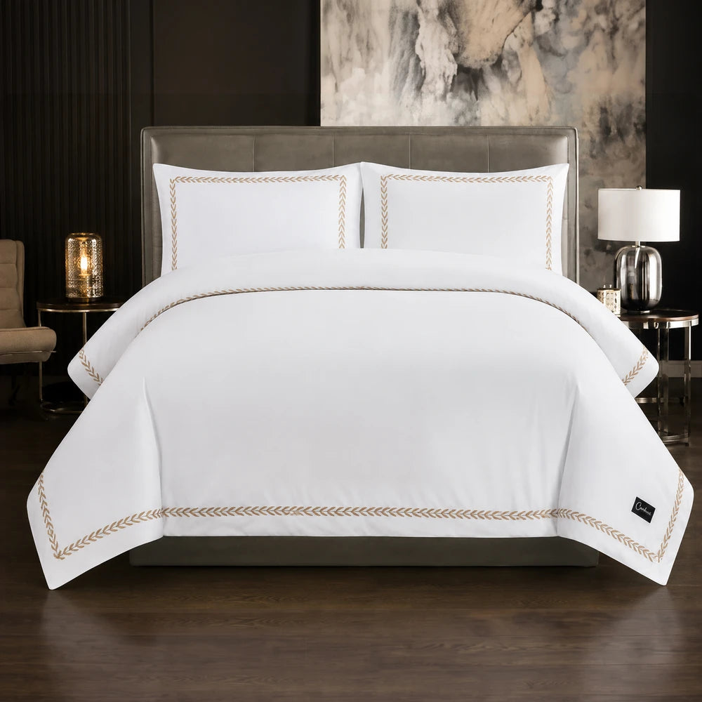 Carducci Serenity 100% cotton bedding in pure white with gold embroidered trim on duvet cover and pillow shams.