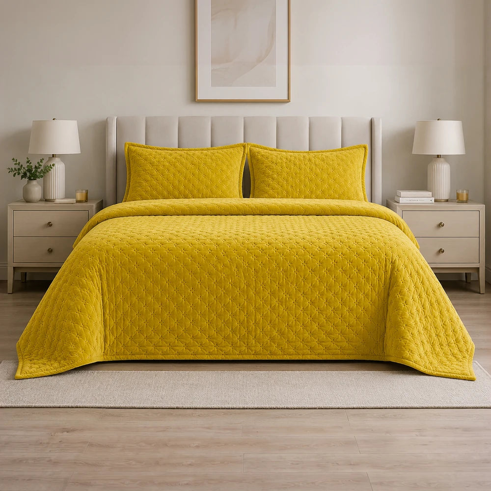 Carducci Velvet Pinsonic Quilt Set in bright yellow with quilted pattern and matching pillow shams on a neutral bed.